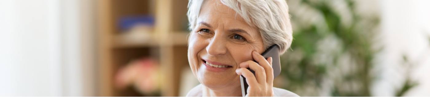 Senior woman talking on the phone with Richardson oral surgery office