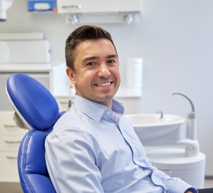 Smiling man sitting in dental chair