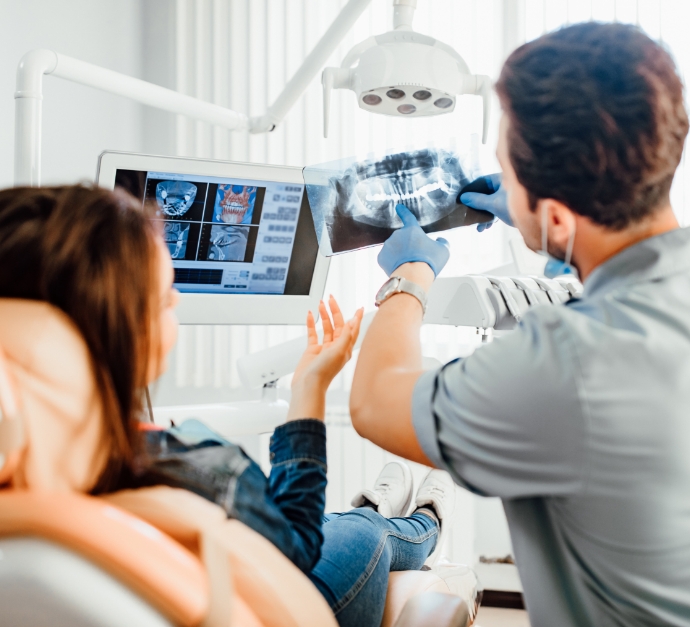 Dentist showing a patient x rays of their teeth