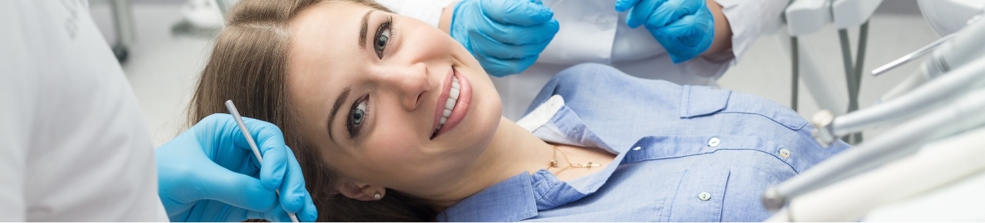 Woman leaning back in dental chair during treatment