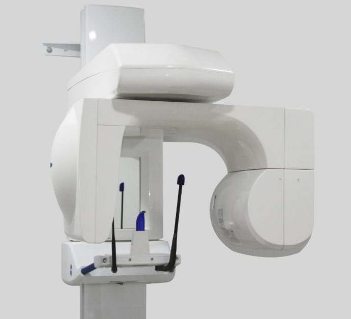 White dental scanning machine standing against white wall