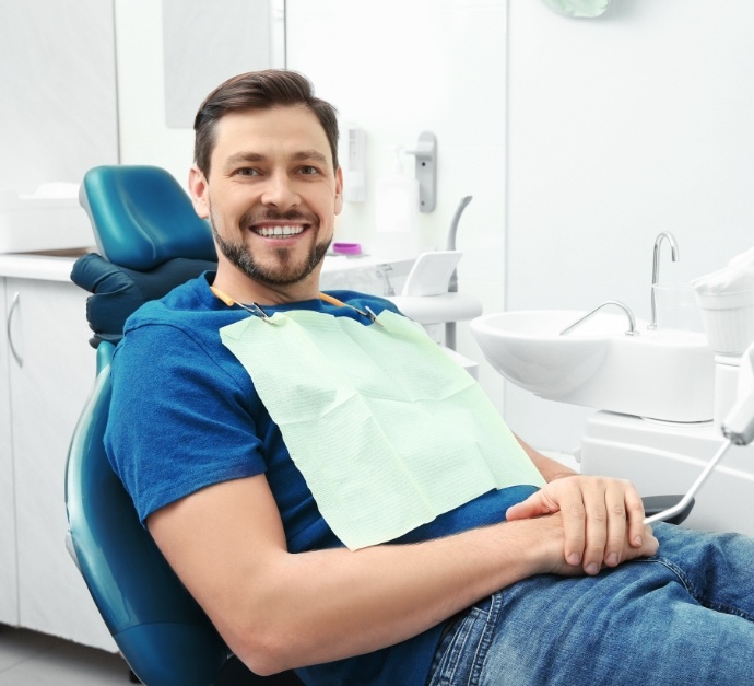 Smiling man sitting in dental chair