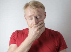 Man covering his mouth with his hand